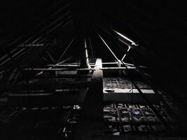 Dark and creepy attic with little daylight photo