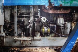 Detail of greasy motor mechanics of an old tractor in need for repair photo