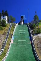 Close-up view of ski jump ramp with stairs and blue sky background in Oberhof, Germany photo