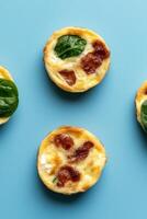 Mini quiche with spinach and bacon on blue background photo