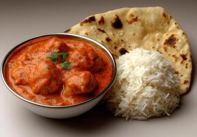 Delicious butter chicken with rice and naan bread photo