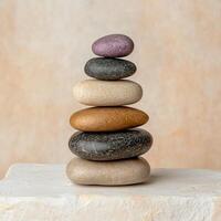 Stack of colorful stones on a white surface photo