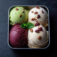 Close up of three scoops of gourmet ice cream in a metal container photo