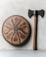 Ancient wooden shield and battle axe on a neutral background photo
