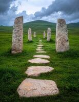 Stone path leading to standing stones in a green field photo