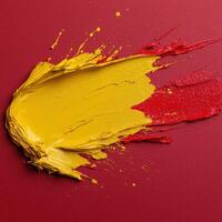 Abstract paint strokes of yellow and red on a textured red background photo