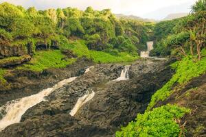Maui, Hawaii, USA - 2024 - Dramatic series of waterfalls of Ohe'o Gulch cascading down a rocky under a bridge, in Haleakala National Park, Kipahula, Maui, Hawaii, USA photo