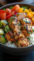 Grilled chicken bowl with vegetables and rice served in a black bowl photo