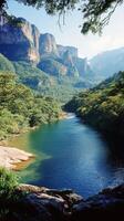 Lush river surrounded by mountains in a vibrant green landscape during daylight hours photo
