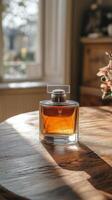 Elegant perfume bottle on wooden table in sunlit room with flowers and soft shadows photo