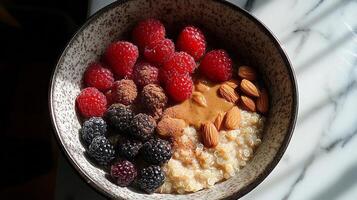 Quinoa bowl topped with berries and almonds served on a kitchen counter photo