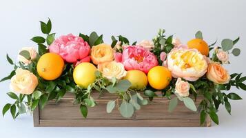Beautiful floral arrangement with peonies and lemons in a wooden box photo