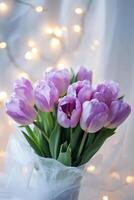 Beautiful bouquet of purple tulips with soft lights creating a cozy atmosphere photo