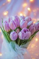 Beautiful bouquet of purple tulips with soft lights creating a cozy atmosphere photo