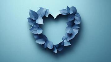 Blue paper leaves creating heart shape against light blue background for decoration or crafts photo