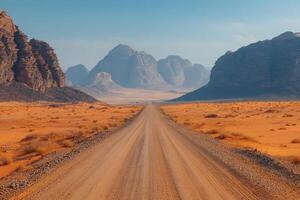 Breathtaking view of a winding desert road in a vast landscape under a bright blue sky photo