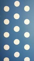 Blue wall adorned with playful white circles creating a cheerful atmosphere for decor or design photo