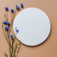 Blue flowers arranged around a white circle on a warm orange background photo