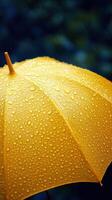 Bright yellow umbrella covered in raindrops during a rainy day photo