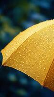 Bright yellow umbrella covered in raindrops during a rainy day photo
