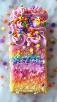 Colorful rainbow cake decorated with icing and sprinkles for a festive celebration photo
