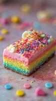 Colorful rainbow cake decorated with icing and sprinkles for a festive celebration photo