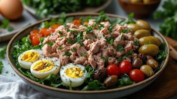Colorful salad bowl with tuna, eggs, tomatoes, and greens arranged artfully for a healthy meal photo
