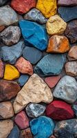 Colorful stones create vibrant texture on weathered wall in outdoor setting photo