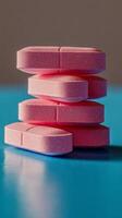 Colorful stack of pink fitness weights against a bright blue background showcasing a modern training setup photo