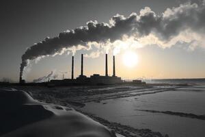 Colorful sunset over snowy street with factory smoke in background during winter evening photo
