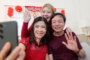 Chinese new year celebration family bonding with grandparents and granddaughter indoor setting heartwarming moments photo