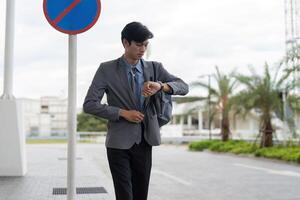 Business professional checking time city street lifestyle image urban environment business concept photo