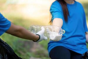 Family volunteers collecting garbage together in nature community event positive action outdoor environment photo