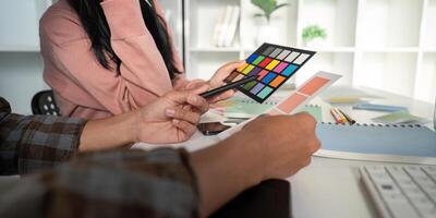 Design team meeting on color charts and graphics in a bright office environment for effective collaboration photo