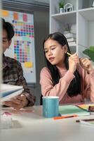 Design team meeting with color charts and graphics in a bright workspace environment photo