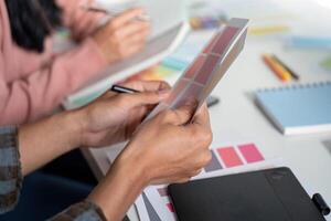 Design team collaborating on graphics development in modern office environment creative workspace productive mindset photo