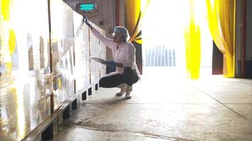 The production supervisor inspects the canned fish boxes that have gone through the packaging process photo