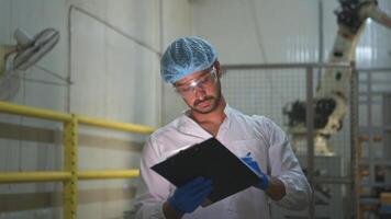 The production supervisor inspects the canned fish boxes that have gone through the packaging process photo