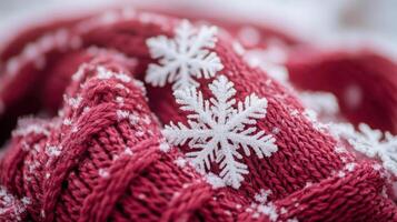 A close up of a red knitted scarf with snowflakes photo