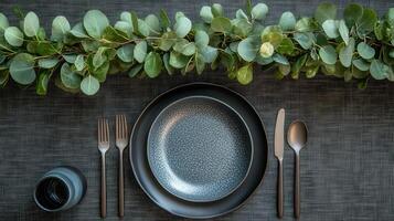 A black plate with silverware and a knife and fork photo