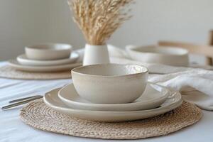 A table setting with white dishes and a bowl photo