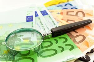 Euro Notes with calculator and magnifier photo