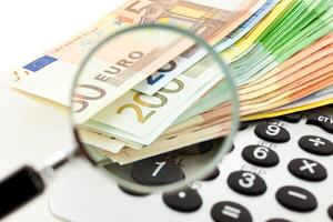 Euro Notes with calculator and magnifier photo