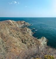 View of the vastness of the Pacific Ocean from the high seashore. High cliffs on the shore of the Pacific Ocean. photo