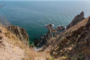 View of the vastness of the Pacific Ocean from the high seashore. High cliffs on the shore of the Pacific Ocean. photo