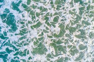 close-up zenith view of seawater on the shore of a beach, textured background marine concept photo