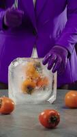 Chef smashes persimmon frozen in a large block of ice with a knife video