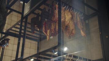 dried and cured meat hanging in a drying machine, bottom view video