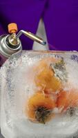 The cook melts frozen persimmon with a torch video