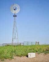 salt block with minerals for cattle and windmill photo